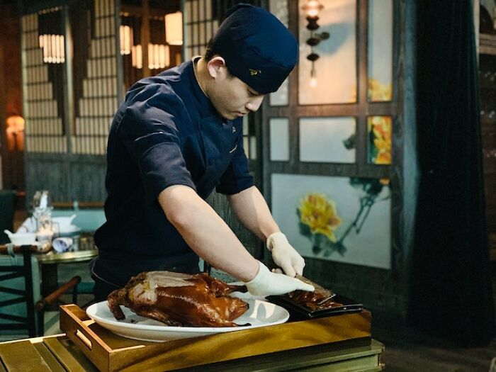 Chef preparing traditional peasant food in a rustic kitchen, highlighting products people can no longer afford today.