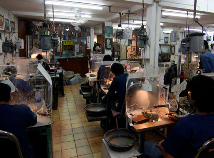 Artisans working on detailed crafts in a workshop, illustrating professions that may soon disappear according to the thread.