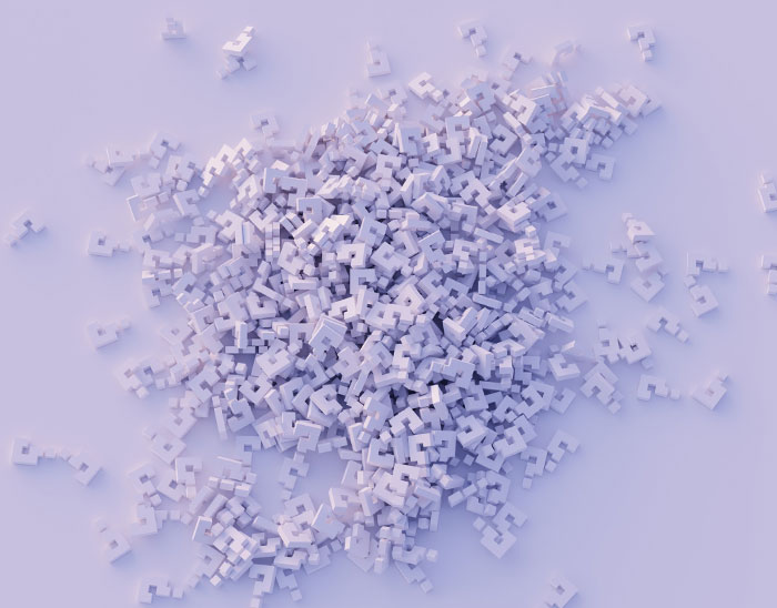 Pile of small white question mark blocks scattered on a light surface representing texting games for phone conversations