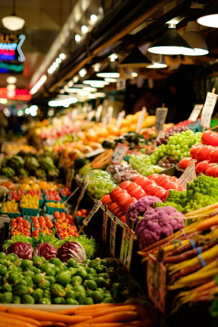 Colorful fresh vegetables and fruits displayed at a market showcasing peasant food products and produce.