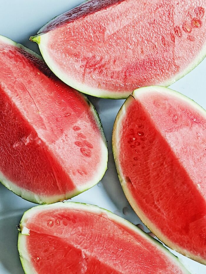 Slices of watermelon arranged on a plate, illustrating peasant food products many can no longer afford.
