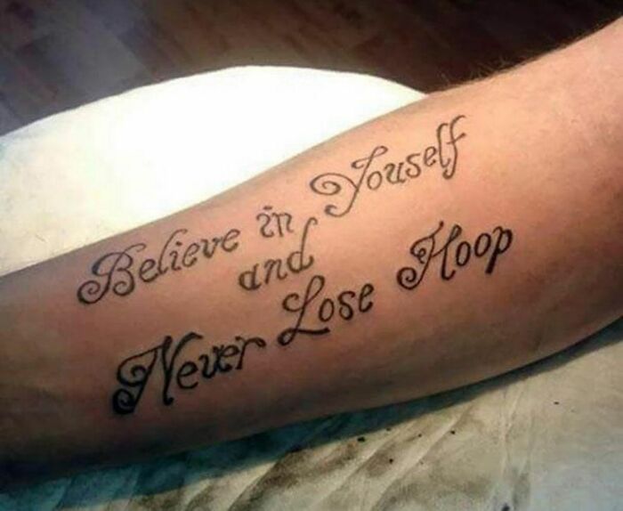 Tattoo saying "Believe in Youself and Never Lose Hoop" on arm, highlighting a funny tattoo mistake.