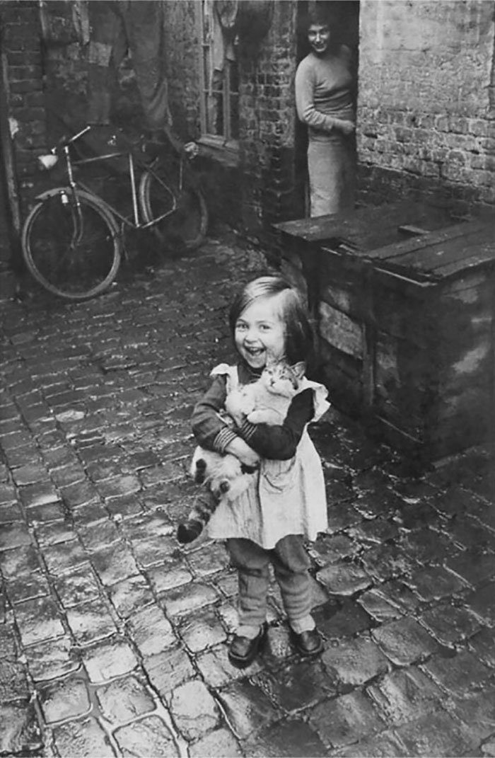 1959. A Young French Girl Poses With Glee As She Cradles Her Cat