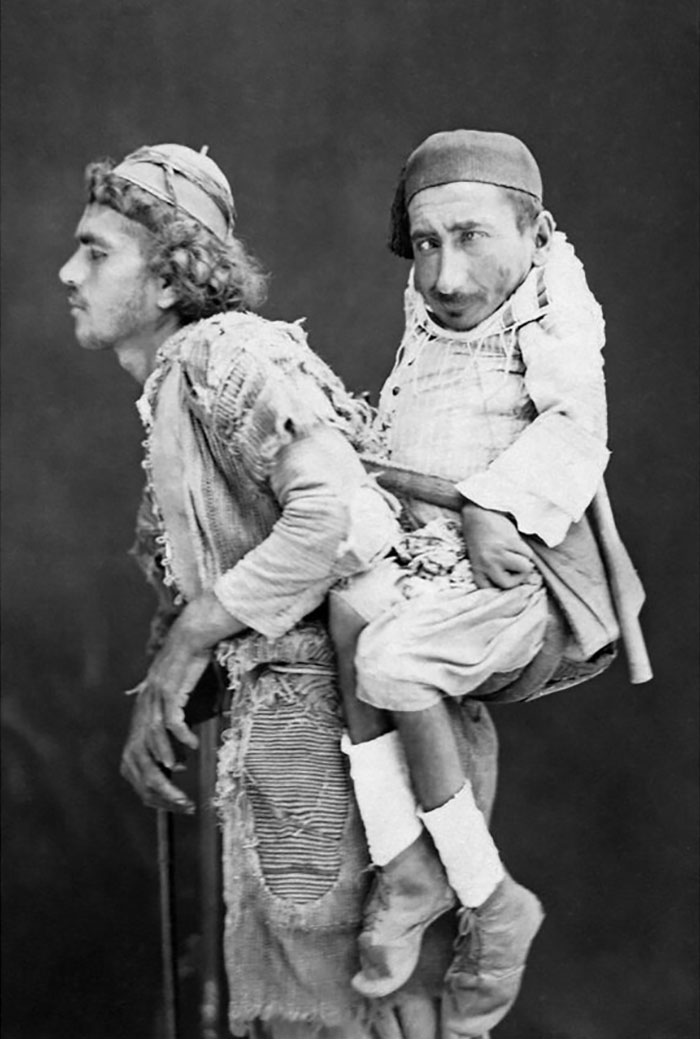 1889. A Blind Man Carrying A Paralyzed Man With Dwarfism In Damascus, Syria. Photo By Italian Photographer Tancrède Dumas