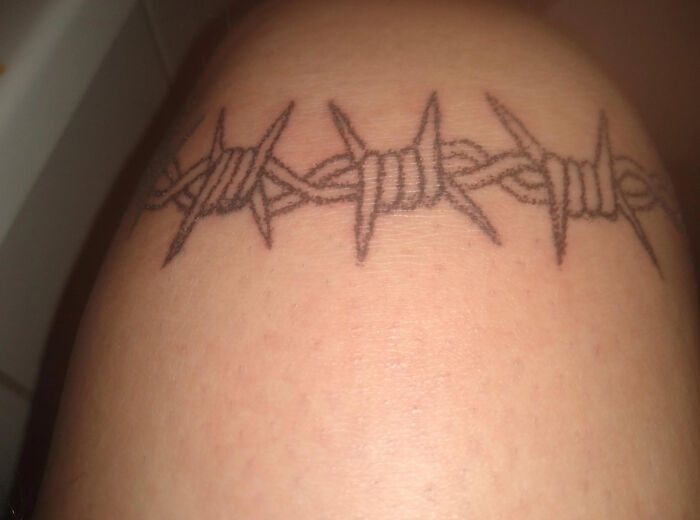 Barbed wire tattoo design on forearm.