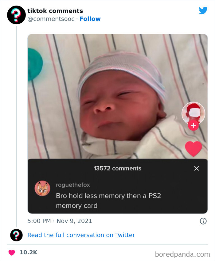Newborn baby wrapped in a blanket with a funny TikTok comment about memory cards shown on screen.