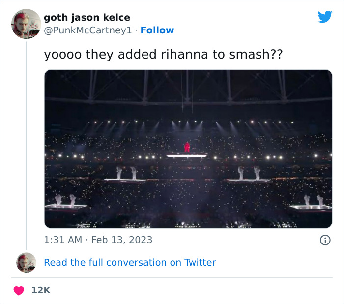 Rihanna performing at Super Bowl 2023, wearing a red outfit, surrounded by dancers on illuminated platforms.