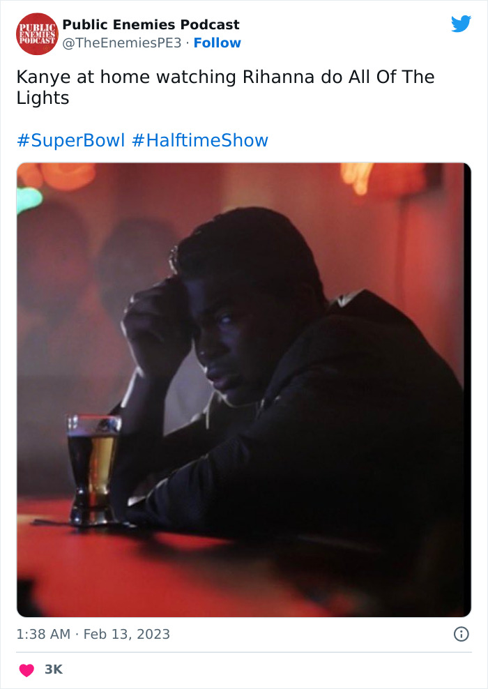 Person sitting at a table with a drink, reacting to Rihanna's Super Bowl 2023 performance meme.