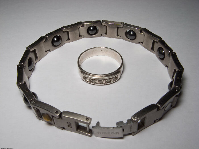 Metal bracelet and ring on a white surface, illustrating common myths.