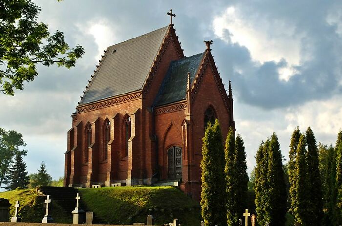 Gothic-style chapel on a hill with crosses and trees, symbolizing the road to hell paved with good intentions.