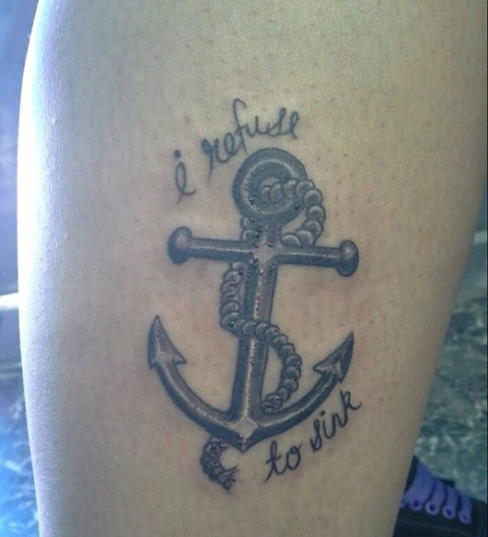 Anchor tattoo with "I refuse to sink" text on skin, relating to cringe tattoo types.