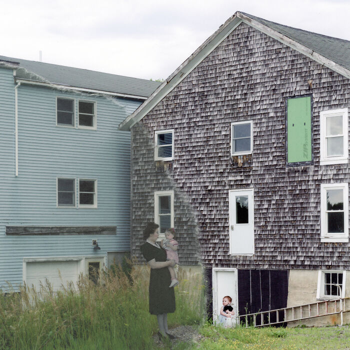 Woman holding a child outside aged wooden house, representing breaking stereotypes in powerful imagery for women