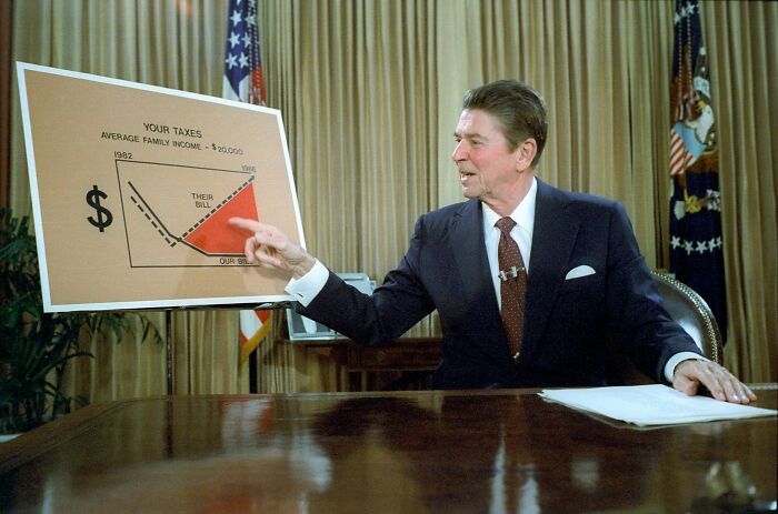 A man in a suit points at a tax chart, highlighting myths in financial data.