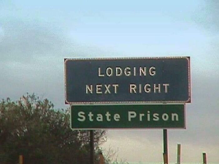 Road sign humor showing lodging next right above the state prison, a hilariously absurd sign shared online.
