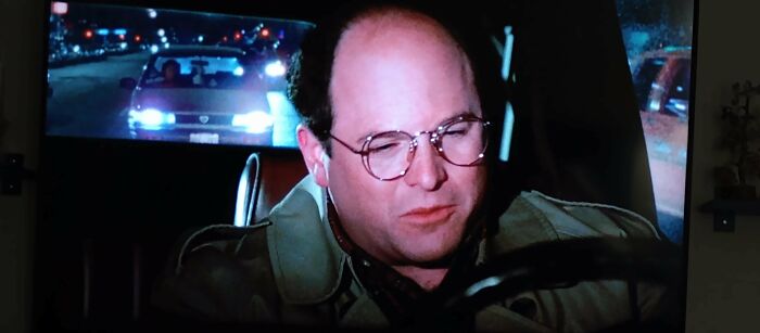 The Person Driving The Car Behind George & Susan Is Driving On The Right-Hand Side Of The Vehicle In NYC. S7 E9: The Sponge (13:40)