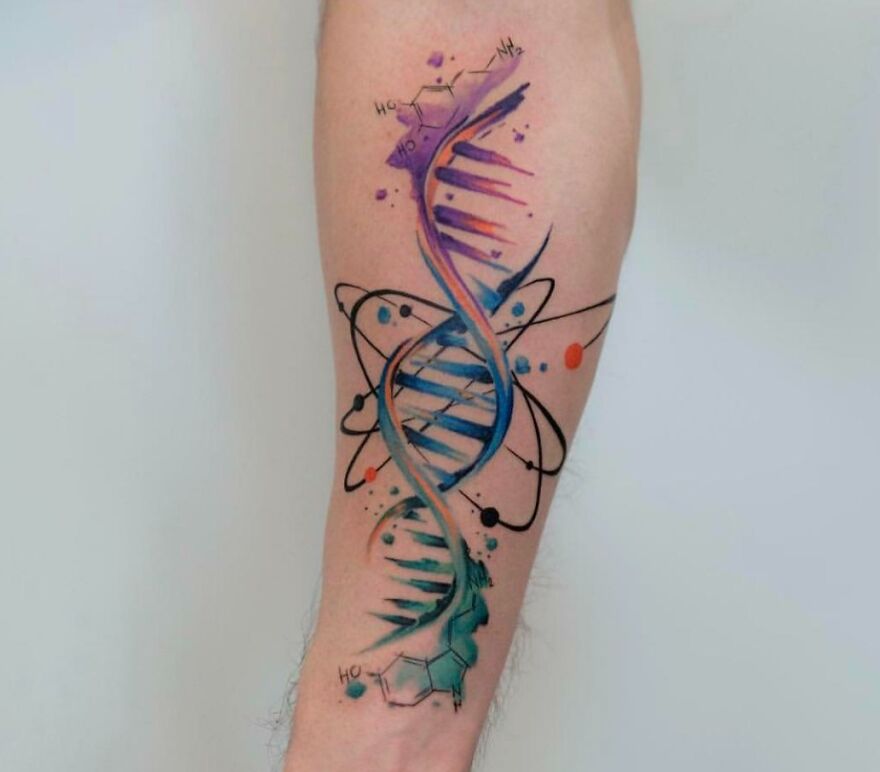 Colorful DNA watercolor tattoo design on forearm with galaxy elements and chemical structures.