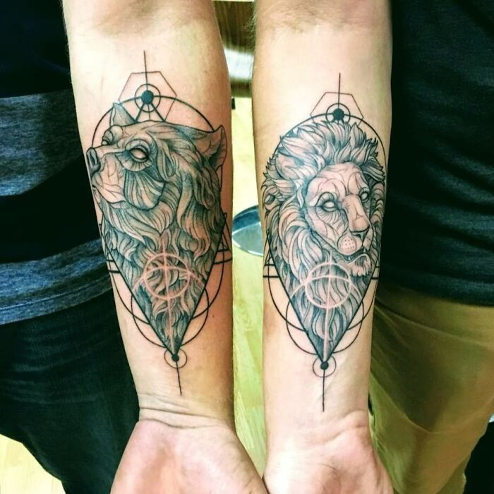 Brother and sister tattoos of a wolf and lion on forearms, symbolizing unity and connection.