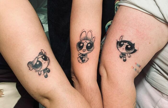 Brother and sister tattoos featuring Powerpuff Girls characters on forearms.