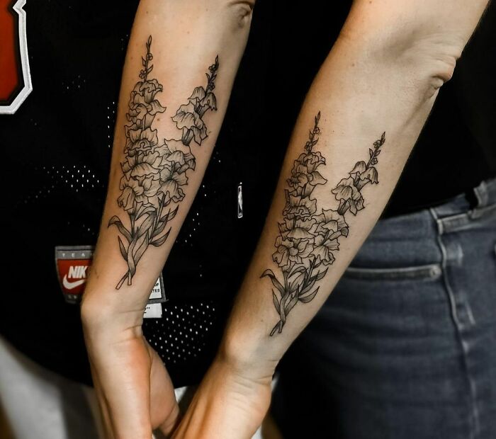 Matching floral tattoos on a brother and sister's arms, symbolizing their inseparable bond.