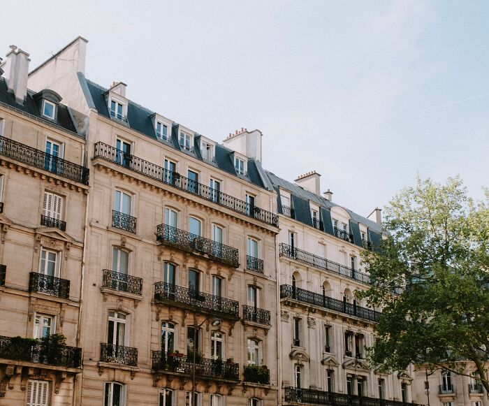 Yellowish building with black roof 