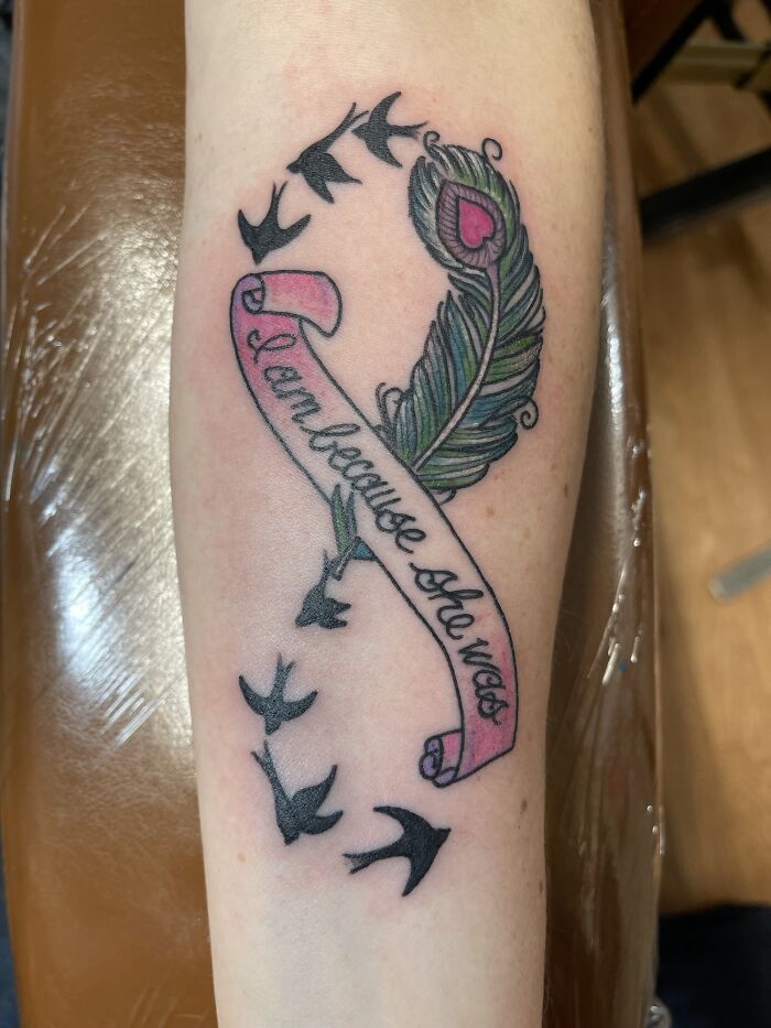 Peacock feather with text tattoo includes birds and scroll design, exemplifying creative word tattoos for inkspiration.