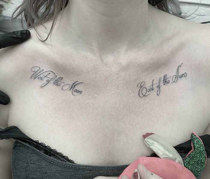 Creative word tattoos on collarbone reading "West of the Moon" and "East of the Sun" for inkspiration.