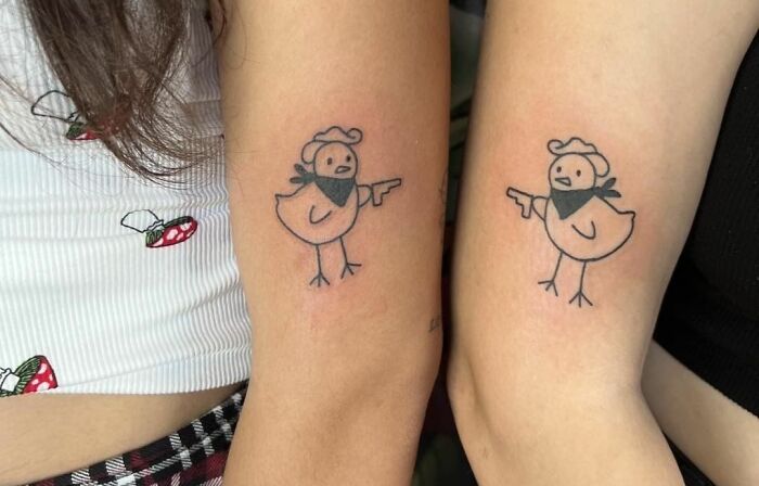 Matching chicken tattoos on friends' arms symbolizing best friend tattoos and celebrating friendship.