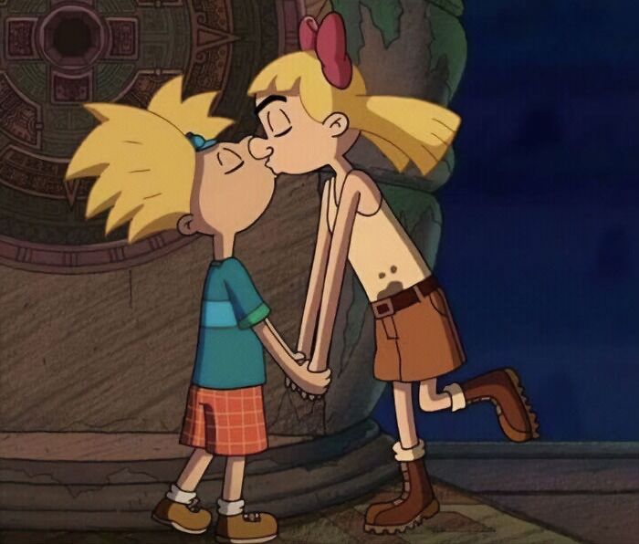 Cartoon couple sharing a sweet kiss, depicting love in a colorful animated setting.
