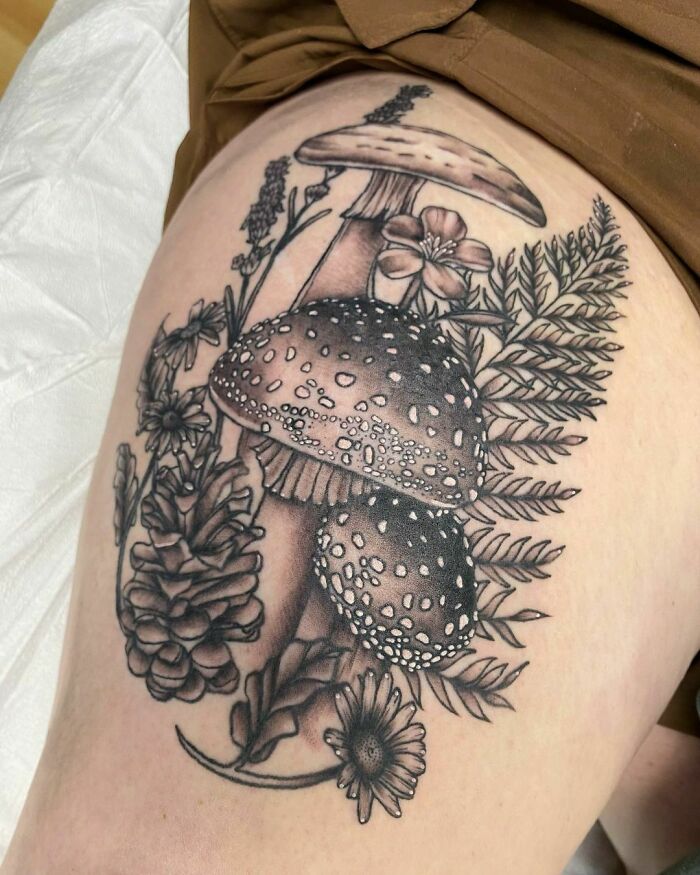 Nature tattoo featuring mushrooms and flowers, symbolizing the human-earth bond.