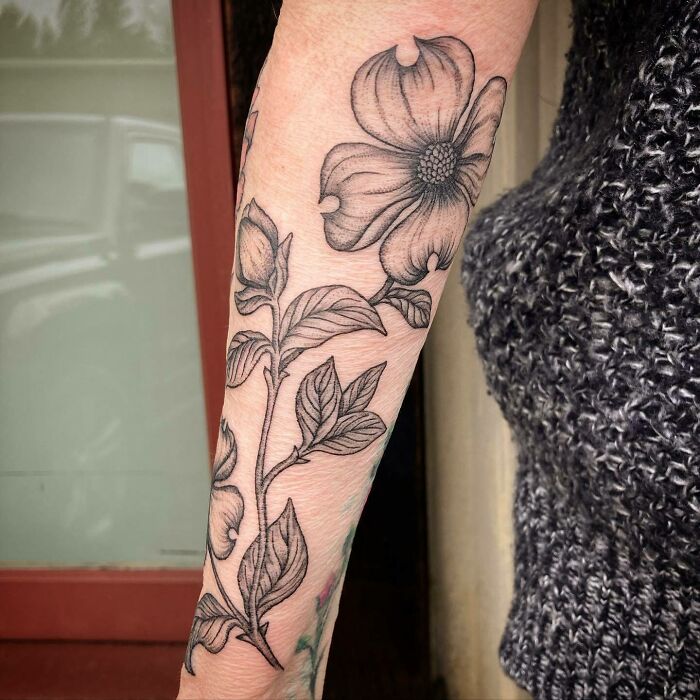 Nature tattoo featuring a detailed floral design on a person's forearm, showcasing the beauty of Mother Earth.