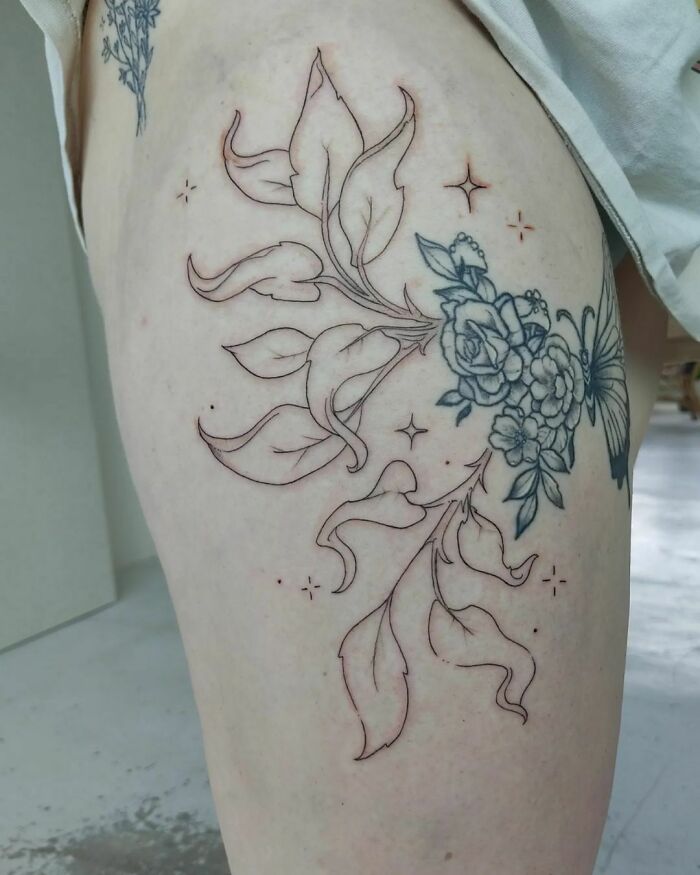 Nature tattoo with floral and leaf design on skin, celebrating Mother Earth's beauty.