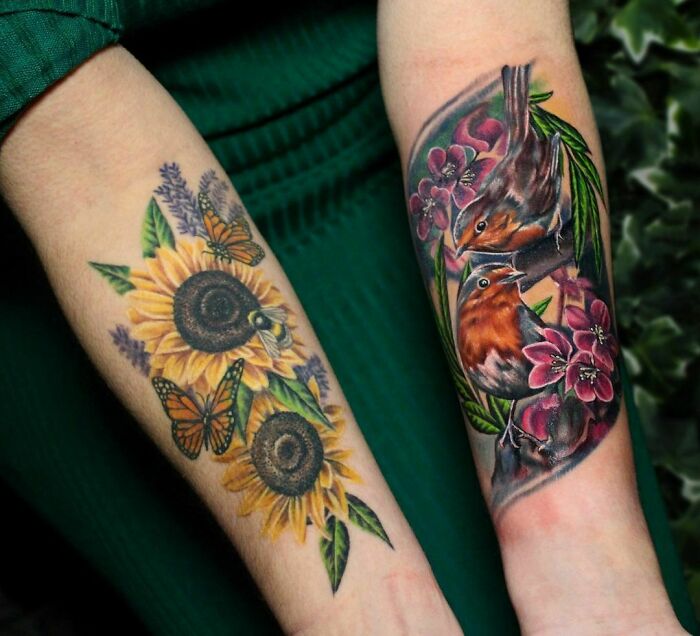 Colorful nature tattoos featuring sunflowers, butterflies, and birds on someone's forearms.