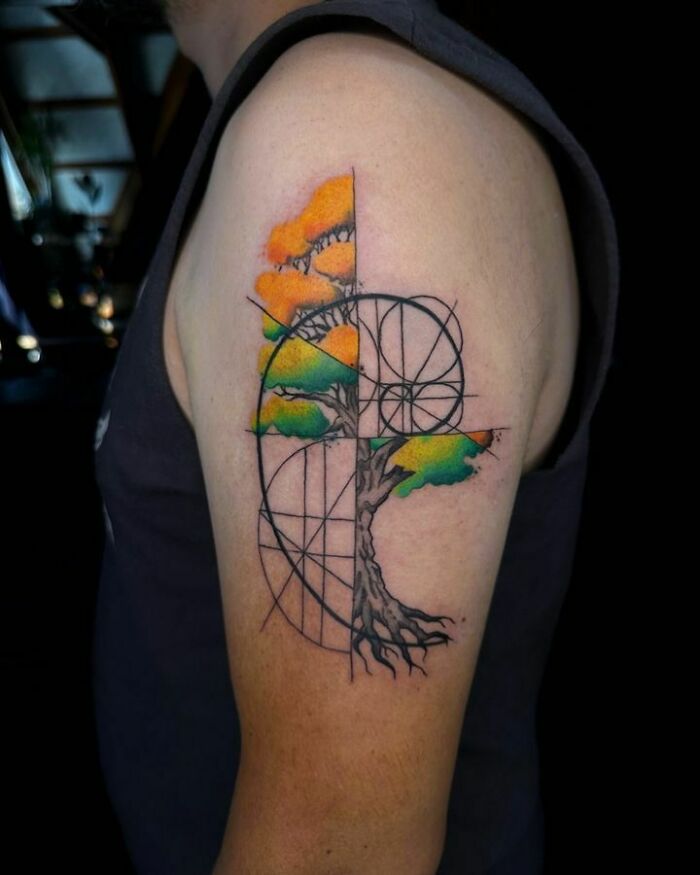 Colorful geometric tree tattoo on an arm, illustrating the beauty of nature.