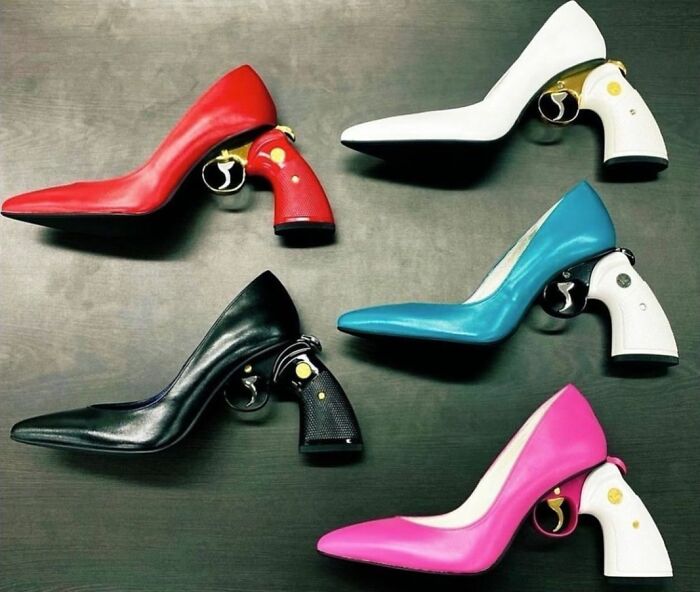Weird shoes with gun-shaped heels in various colors on display.