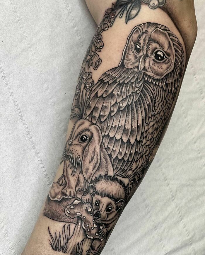 Nature tattoos featuring an owl, rabbit, and hedgehog with detailed shading on an arm.