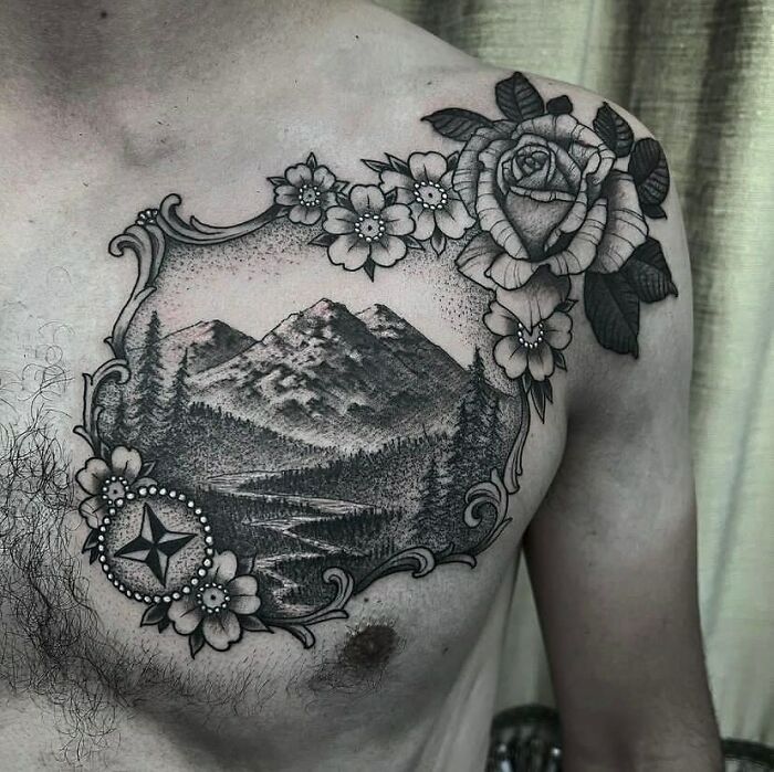 Chest tattoo featuring mountains and floral designs, symbolizing a wild, nature-inspired aesthetic.