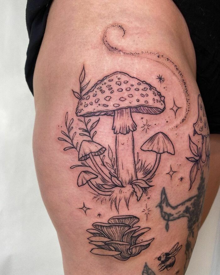 Nature tattoos featuring detailed mushroom designs on the thigh, symbolizing the wonders of Mother Earth.