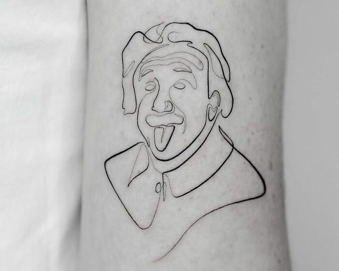 Single-line tattoo of a man's face with iconic tongue-out expression.