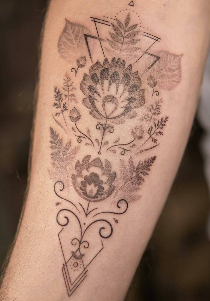 Intricate nature tattoo featuring floral and leaf patterns with geometric shapes, showcasing a wild side theme.