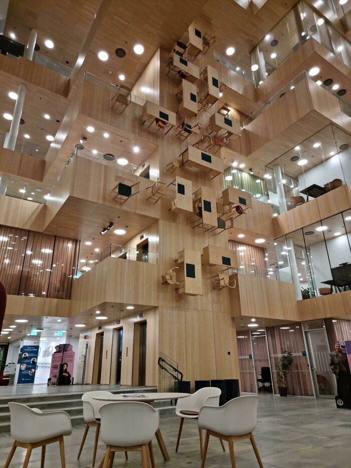 This Building Im In Has Chairs And Desks Mounted On The Wall