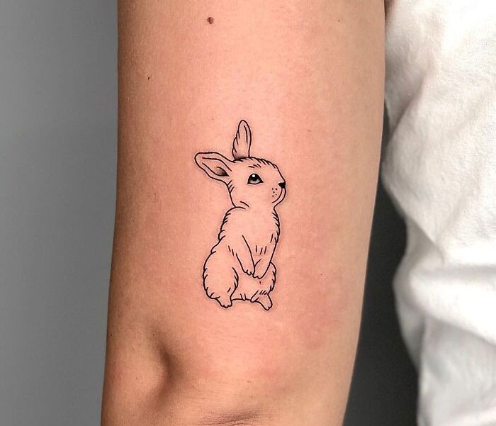 Minimalist rabbit animal tattoo on an arm, showcasing artistic ink design for tattoo inspiration.