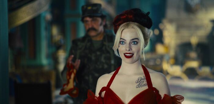 Harley wearing red dress and hat 