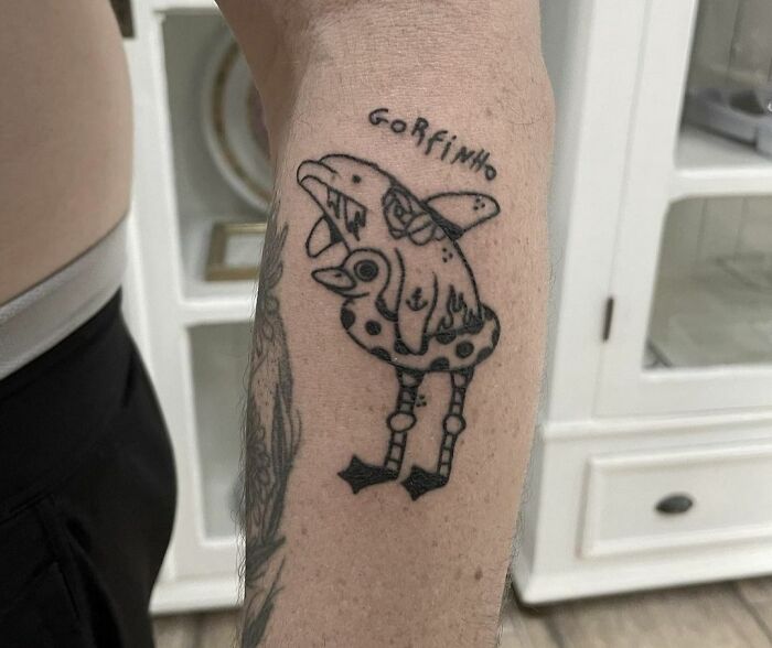 Funny tattoo of a quirky cartoon character on an arm, designed to make you smile.