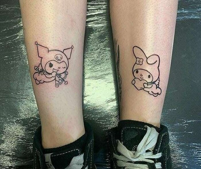 Cartoon-themed BFF tattoos on calves, showcasing friendship with cute characters.