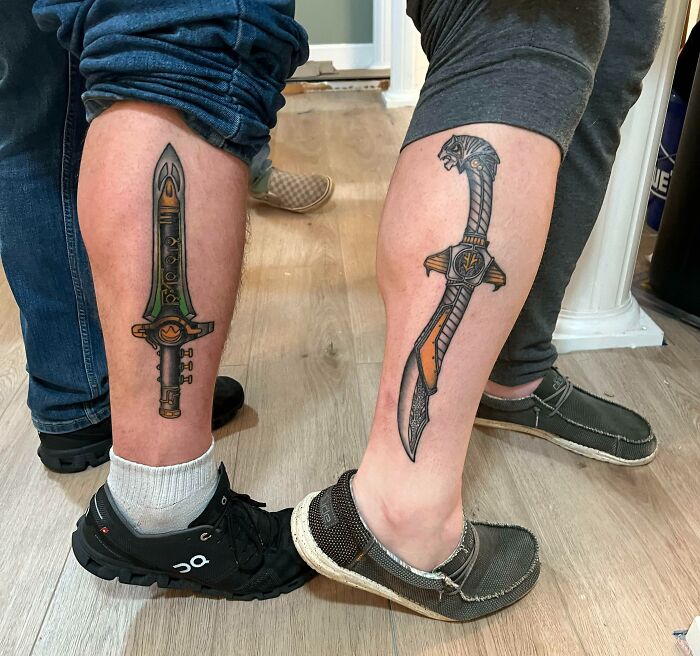BFF tattoo ideas featuring matching sword designs on legs symbolizing friendship and adventure.