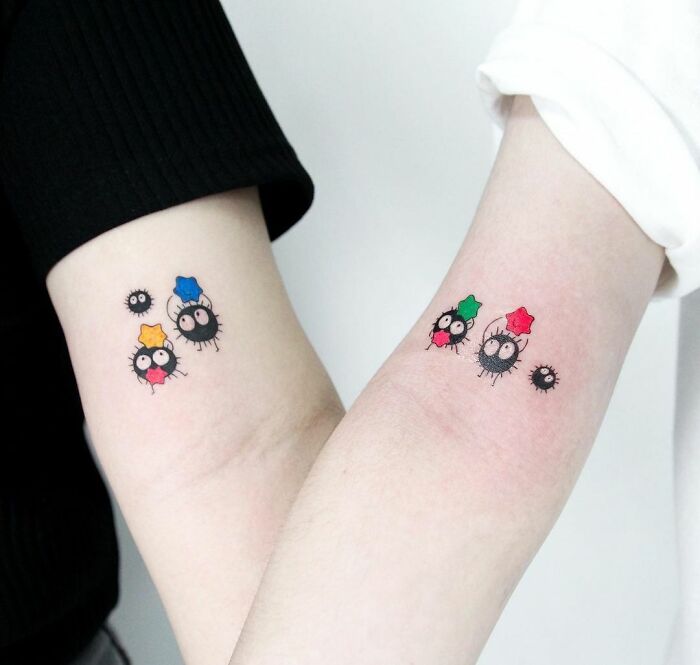 Cute BFF tattoos on forearms with colorful star designs and cartoon characters, symbolizing friendship.