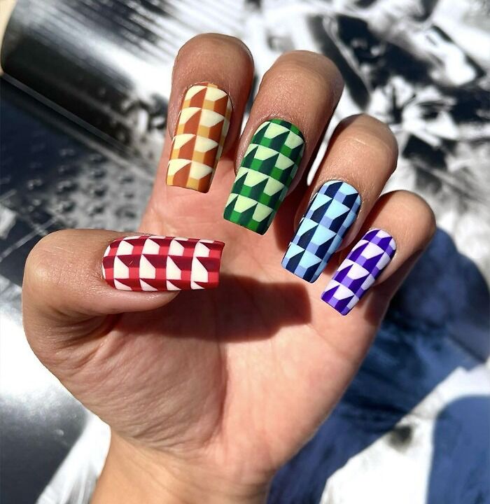 Colorful nail art ideas featuring geometric patterns in red, orange, green, blue, and purple on long nails.