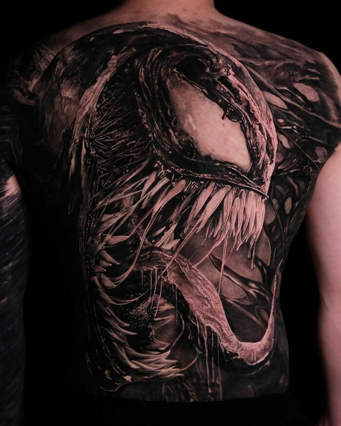 Back with a detailed Marvel tattoo design featuring a fierce, monstrous creature, showcasing intricate artistry.