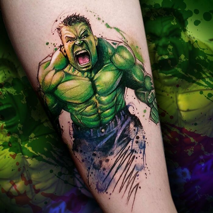 Marvel tattoo of green superhero Hulk in dynamic pose, designed with vivid colors on forearm.