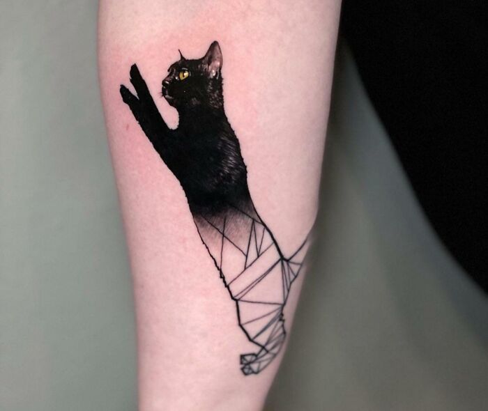Geometric tattoo of a black cat with abstract shapes on forearm, showcasing creativity and forms.